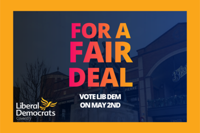 The text 'FOR A FAIR DEAL VOTE LIB DEM ON MAY 2ND' overlaying the statue of Lady Godiva in Coventry City Centre