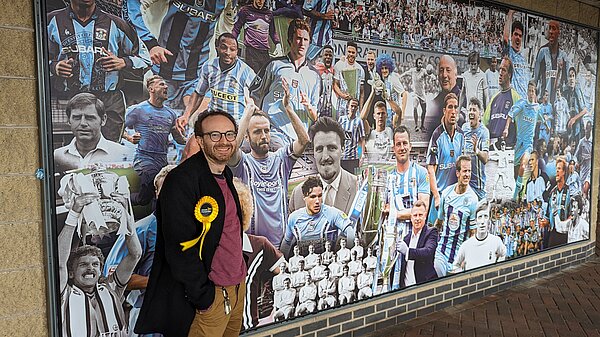 Stephen Richmond stood outside the Sky Blues mural at the Coventry Building Society Arena